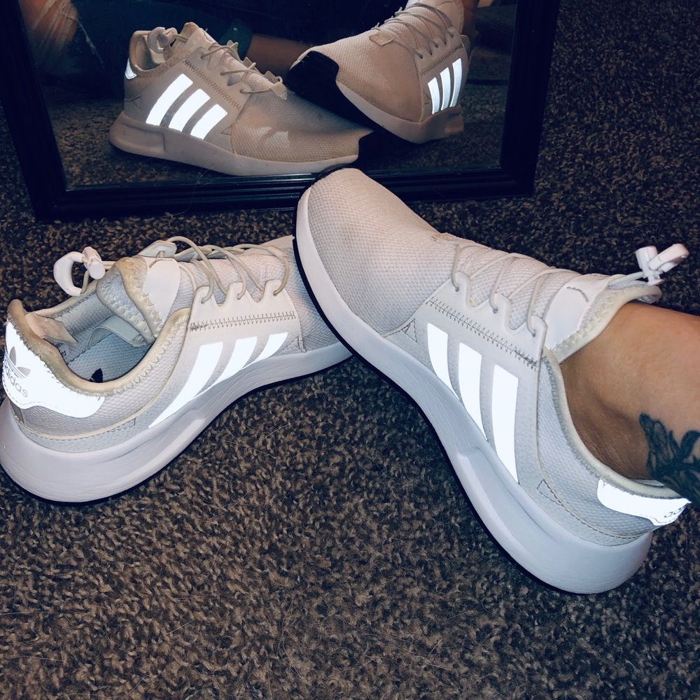 All white Adidas running shoes